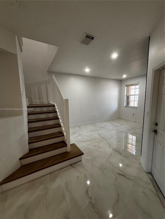 basement featuring recessed lighting, stairway, visible vents, and marble finish floor