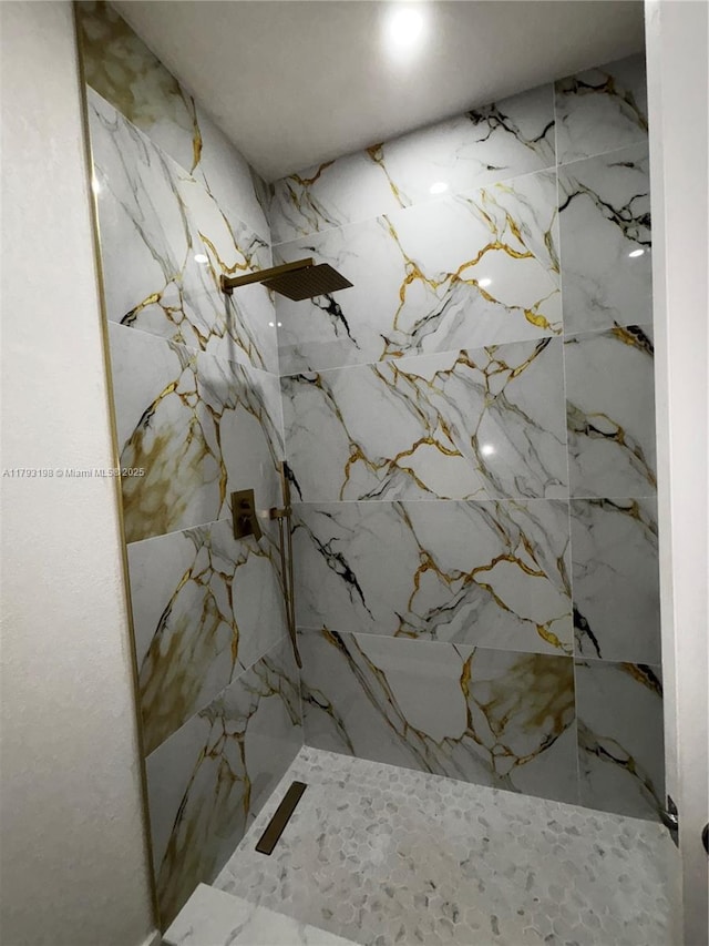 bathroom with a marble finish shower