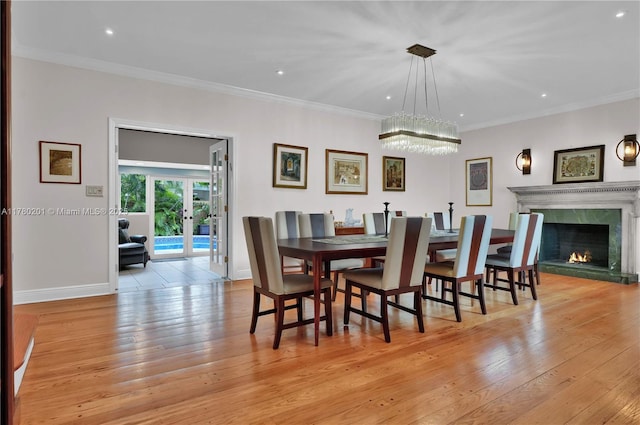 dining area featuring an inviting chandelier, light wood finished floors, french doors, recessed lighting, and baseboards