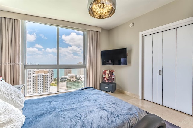 495 Brickell Ave Unit 2801, Miami, FL 33131 - tiled bedroom featuring baseboards and a closet