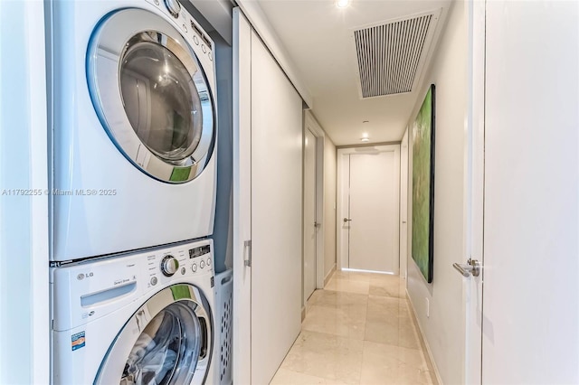 495 Brickell Ave Unit 2801, Miami, FL 33131 - laundry room featuring visible vents, laundry area, marble finish floor, stacked washer / dryer, and baseboards