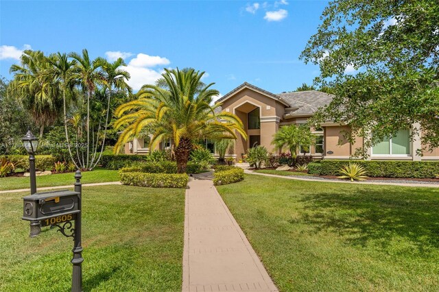 10605 Indian Trl, Cooper City, FL 33328 - mediterranean / spanish-style house featuring stucco siding and a front lawn
