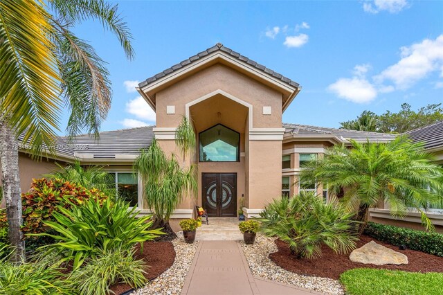 10605 Indian Trl, Cooper City, FL 33328 - entrance to property featuring a tiled roof and stucco siding