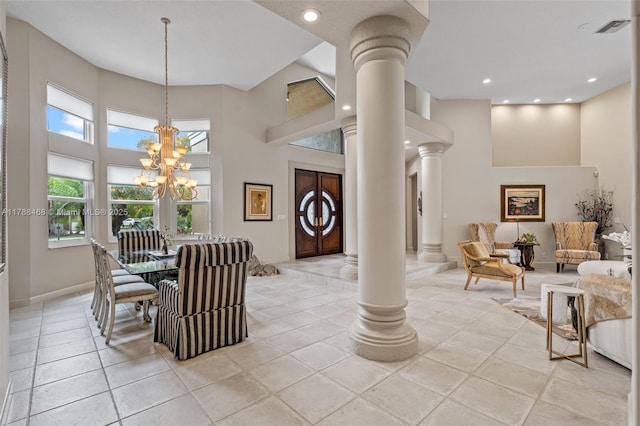 10605 Indian Trl, Cooper City, FL 33328 - dining room featuring visible vents, an inviting chandelier, decorative columns, a high ceiling, and light tile patterned floors