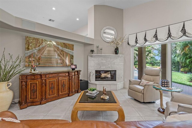 10605 Indian Trl, Cooper City, FL 33328 - living area with a fireplace, visible vents, light tile patterned floors, and a towering ceiling