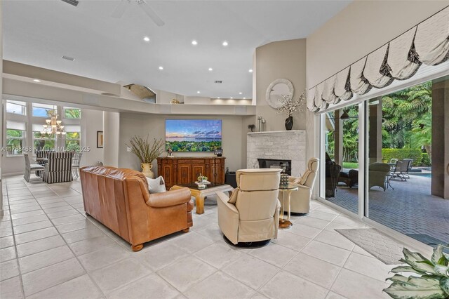 10605 Indian Trl, Cooper City, FL 33328 - living area with light tile patterned floors, ceiling fan with notable chandelier, recessed lighting, and a stone fireplace
