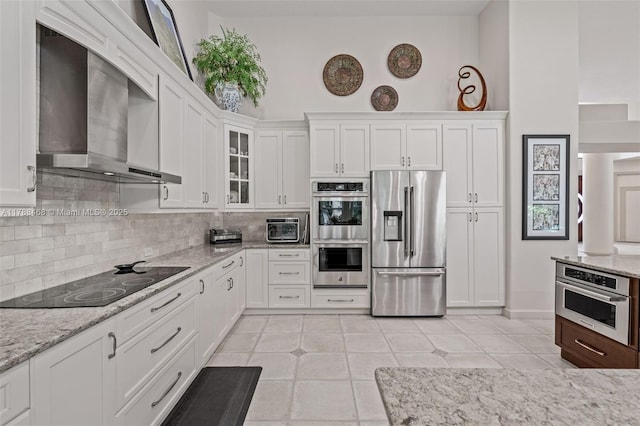 10605 Indian Trl, Cooper City, FL 33328 - kitchen with white cabinets, stainless steel appliances, wall chimney exhaust hood, and tasteful backsplash