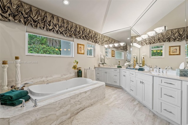 10605 Indian Trl, Cooper City, FL 33328 - full bath with a sink, double vanity, marble finish floor, vaulted ceiling, and a garden tub