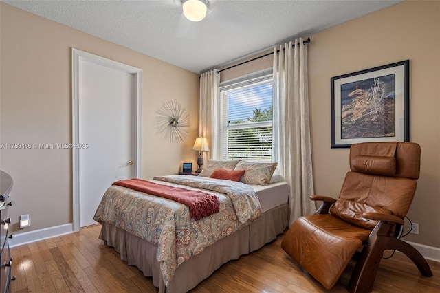 10605 Indian Trl, Cooper City, FL 33328 - bedroom featuring baseboards, light wood-type flooring, and a textured ceiling