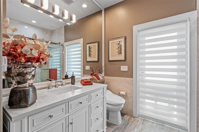 10605 Indian Trl, Cooper City, FL 33328 - bathroom with visible vents, tile walls, a shower stall, vanity, and toilet