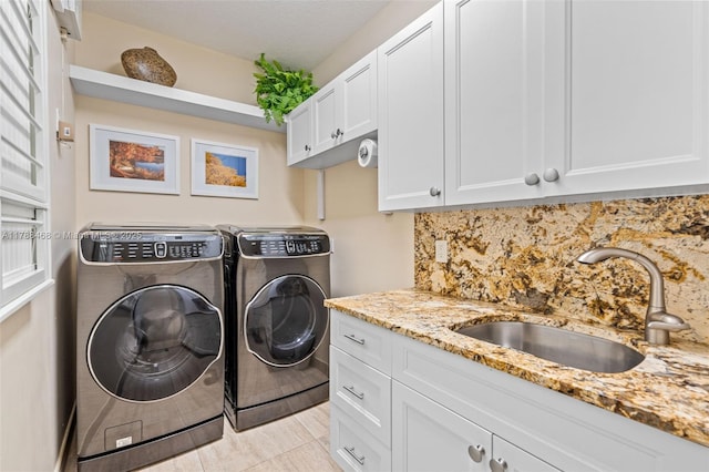 10605 Indian Trl, Cooper City, FL 33328 - clothes washing area with a sink, cabinet space, light tile patterned floors, and washing machine and clothes dryer
