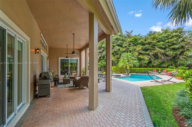 10605 Indian Trl, Cooper City, FL 33328 - view of patio featuring area for grilling, ceiling fan, a fenced in pool, and an outdoor hangout area