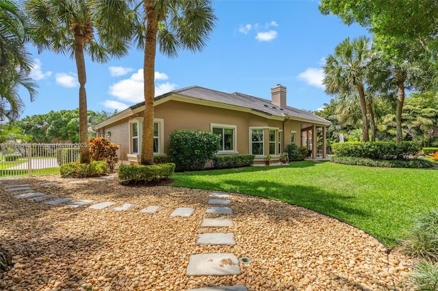 10605 Indian Trl, Cooper City, FL 33328 - rear view of property with a lawn, fence, a chimney, and stucco siding