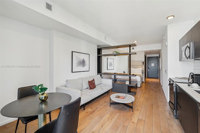 398 NE 5th St Unit 1805, Miami, FL 33132 - living room featuring visible vents, recessed lighting, and light wood finished floors