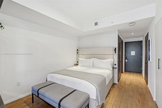 398 NE 5th St Unit 1805, Miami, FL 33132 - bedroom with baseboards, visible vents, and light wood-type flooring
