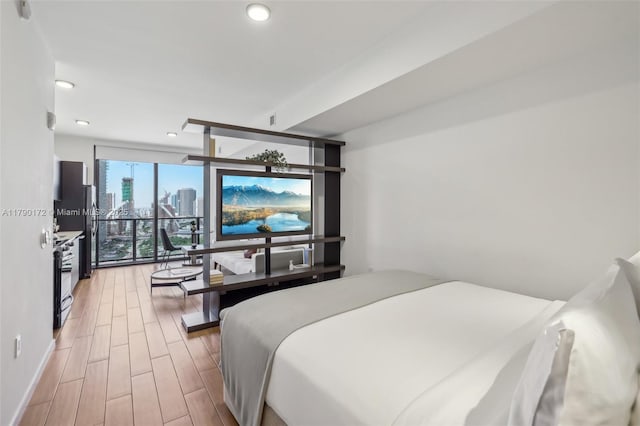 398 NE 5th St Unit 1805, Miami, FL 33132 - bedroom featuring baseboards, floor to ceiling windows, recessed lighting, and light wood-style flooring