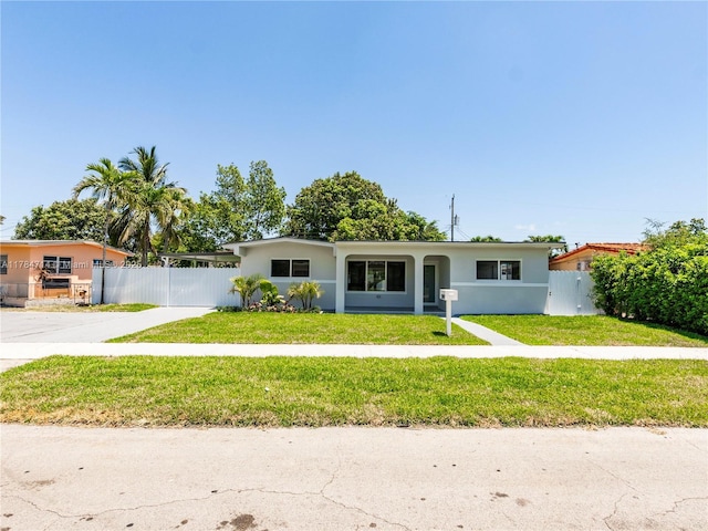 5397 W 14th Ct, Hialeah, FL 33012 - ranch-style home with stucco siding, fence, driveway, and a front yard