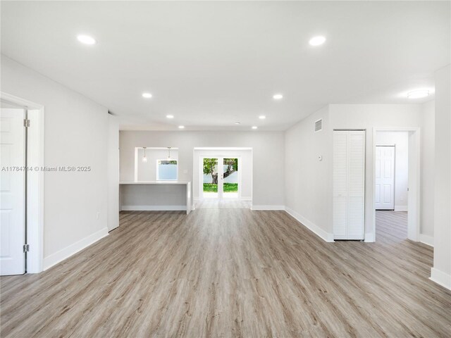 5397 W 14th Ct, Hialeah, FL 33012 - unfurnished living room featuring baseboards, light wood-type flooring, recessed lighting, and visible vents