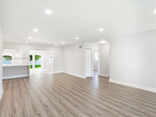 5397 W 14th Ct, Hialeah, FL 33012 - unfurnished living room featuring baseboards, light wood-type flooring, recessed lighting, and visible vents
