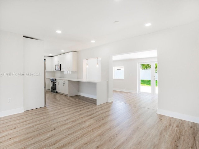 5397 W 14th Ct, Hialeah, FL 33012 - unfurnished living room with light wood-type flooring, recessed lighting, and baseboards
