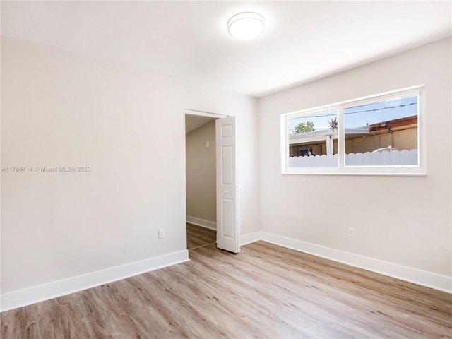 5397 W 14th Ct, Hialeah, FL 33012 - spare room with light wood-style floors and baseboards