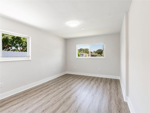 5397 W 14th Ct, Hialeah, FL 33012 - spare room with baseboards, a wealth of natural light, and wood finished floors