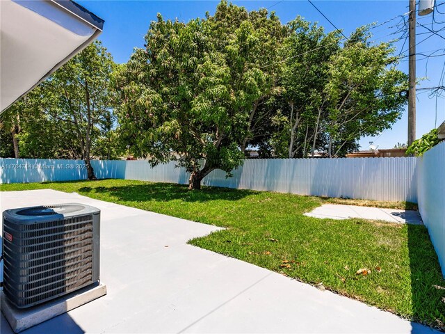 5397 W 14th Ct, Hialeah, FL 33012 - view of yard featuring central AC, a fenced backyard, and a patio area