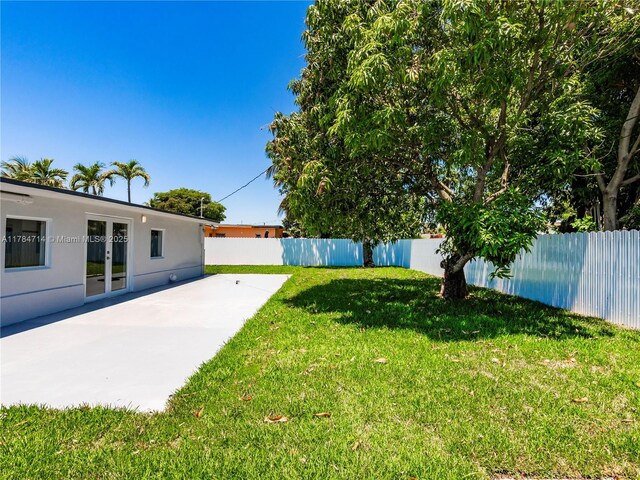 5397 W 14th Ct, Hialeah, FL 33012 - view of yard featuring a fenced backyard, a patio, and french doors