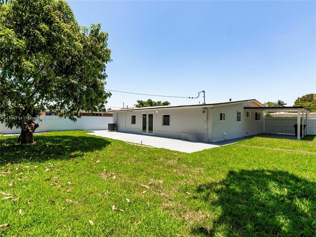 5397 W 14th Ct, Hialeah, FL 33012 - back of house with a yard, a patio, fence, and central AC unit