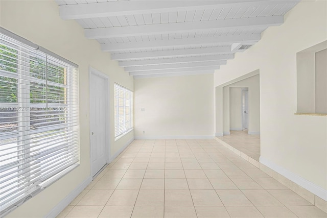 spare room featuring baseboards, wooden ceiling, light tile patterned floors, beamed ceiling, and visible vents