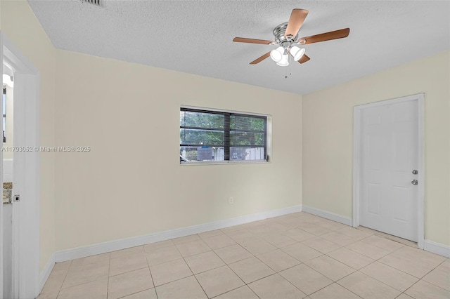 empty room featuring baseboards, ceiling fan, and a textured ceiling