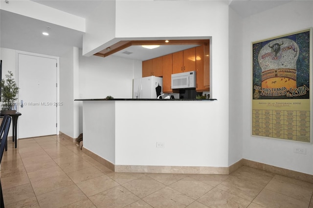 801 Brickell Key Blvd Unit 3105, Miami, FL 33131 - kitchen featuring recessed lighting, dark countertops, light tile patterned floors, and white appliances