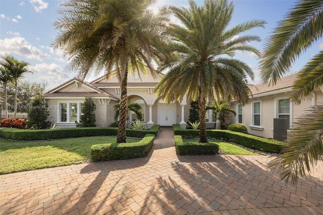 4991 E Sterling Ranch Cir, Davie, FL 33314 - view of front of property with stucco siding, french doors, and a front lawn