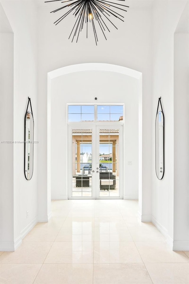 4991 E Sterling Ranch Cir, Davie, FL 33314 - spare room with french doors, baseboards, tile patterned floors, and a towering ceiling