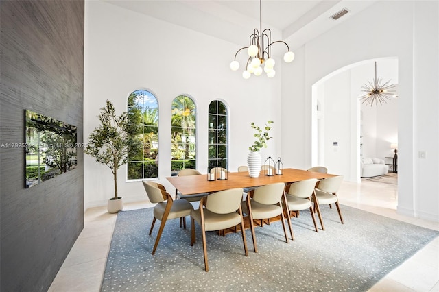 4991 E Sterling Ranch Cir, Davie, FL 33314 - tiled dining room with arched walkways, a high ceiling, a chandelier, and baseboards