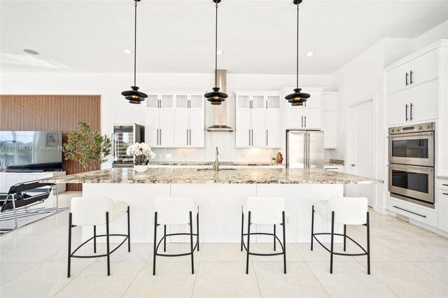 4991 E Sterling Ranch Cir, Davie, FL 33314 - kitchen featuring appliances with stainless steel finishes, a sink, a kitchen bar, white cabinets, and recessed lighting