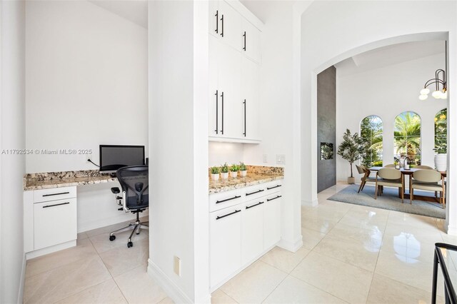 4991 E Sterling Ranch Cir, Davie, FL 33314 - office space with arched walkways, a high ceiling, light tile patterned floors, and baseboards