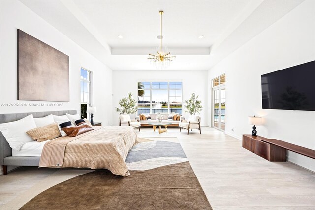 4991 E Sterling Ranch Cir, Davie, FL 33314 - bedroom featuring wood finished floors, a chandelier, a raised ceiling, multiple windows, and recessed lighting