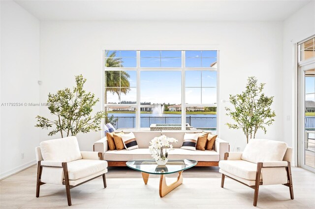 4991 E Sterling Ranch Cir, Davie, FL 33314 - living room with a water view and light wood-style flooring