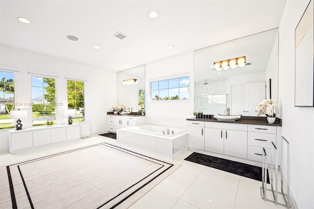 4991 E Sterling Ranch Cir, Davie, FL 33314 - bathroom with plenty of natural light, two vanities, a garden tub, a walk in shower, and recessed lighting