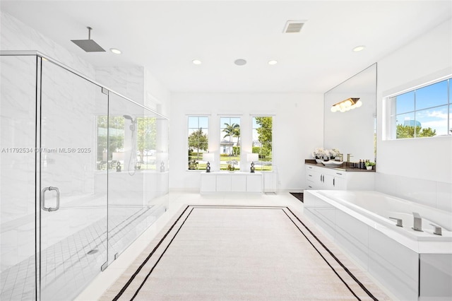 4991 E Sterling Ranch Cir, Davie, FL 33314 - full bathroom with a garden tub, a marble finish shower, healthy amount of natural light, vanity, and recessed lighting