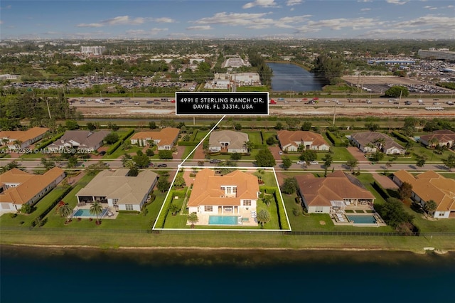 4991 E Sterling Ranch Cir, Davie, FL 33314 - aerial perspective of suburban area with a large body of water and property parcel outlined