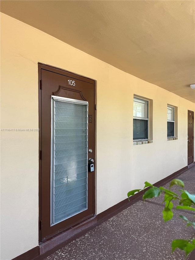 property entrance featuring stucco siding