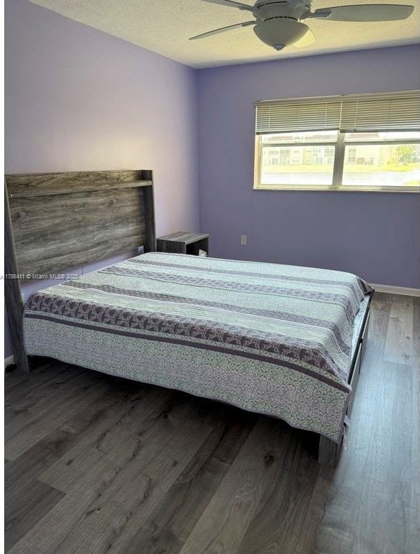 bedroom featuring ceiling fan and wood finished floors