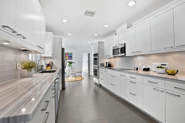 13605 SW 73rd Ave, Palmetto Bay, FL 33158 - kitchen featuring stainless steel appliances, a sink, decorative backsplash, white cabinetry, and recessed lighting