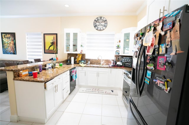 kitchen featuring black fridge with ice dispenser, ornamental molding, a peninsula, dishwashing machine, and dark stone counters