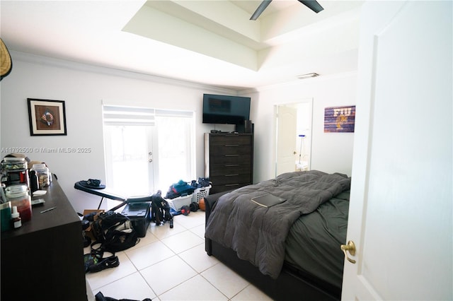 bedroom featuring crown molding, light tile patterned flooring, ceiling fan, and visible vents