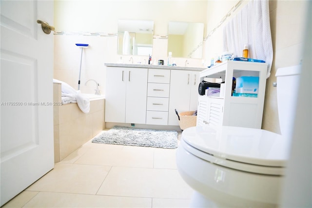 full bath featuring double vanity, toilet, and tile patterned flooring