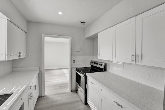 kitchen with recessed lighting, light wood-type flooring, white cabinetry, and electric stove