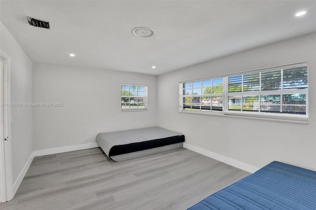 bedroom with recessed lighting, baseboards, visible vents, and wood finished floors